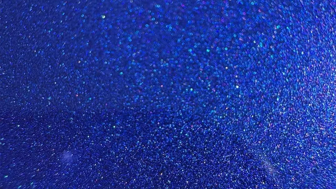 Close-up of ceramic-coated blue metallic flake paint showing clarity and depth after coating