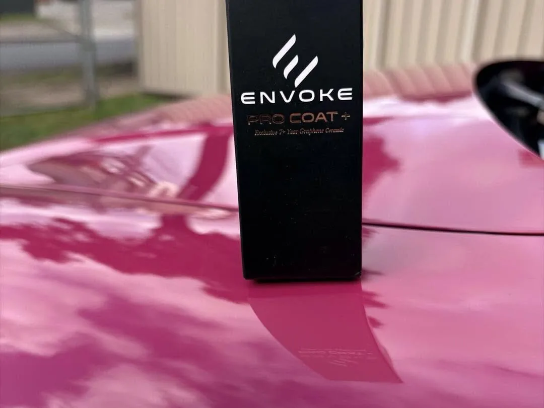 Envoke Pro Coat+ graphene ceramic coating box on a freshly coated pink bonnet, DJM Detailing Bendigo