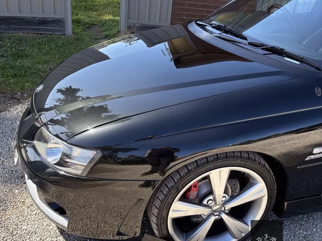 Swirl-free black Holden Commodore bonnet after multi-stage paint correction with Angelwax at DJM Detailing
